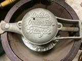 There are three White Mountain ice cream freezers of different ages here, including this one, small and very old