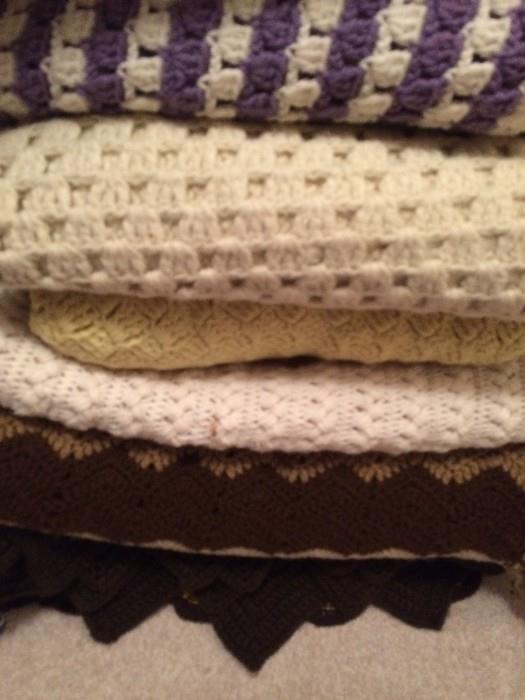 Stacks of full-size and throw crochet afghans, perfect condition