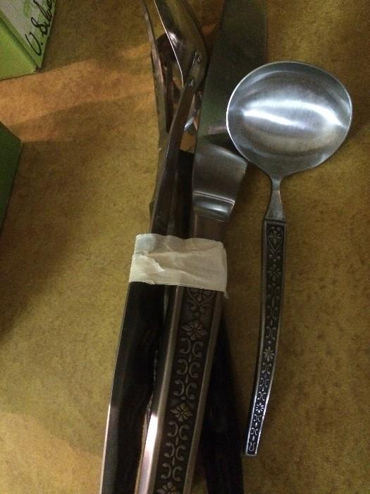 Cordova stainless flatware and complete -- as in over 20 -- serving utensils plus 