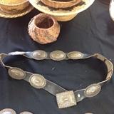 Overall of concho belt with signed buckle.