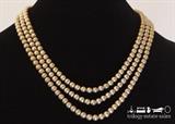Unmarked 48" gold-tone textured metal beads necklace with spring ring closure.