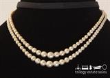 Unmarked 14" graduated size double strand faux pearl necklace with filigreed sterling silver box clasp.