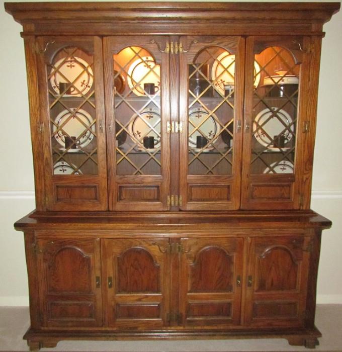 Ennius Interiors of Boise Idaho Solid Oak & Veneer Buffet & Lighted Hutch. The Kensington Place Style Deeply carved and sculptured reflects the splendor of the English Court