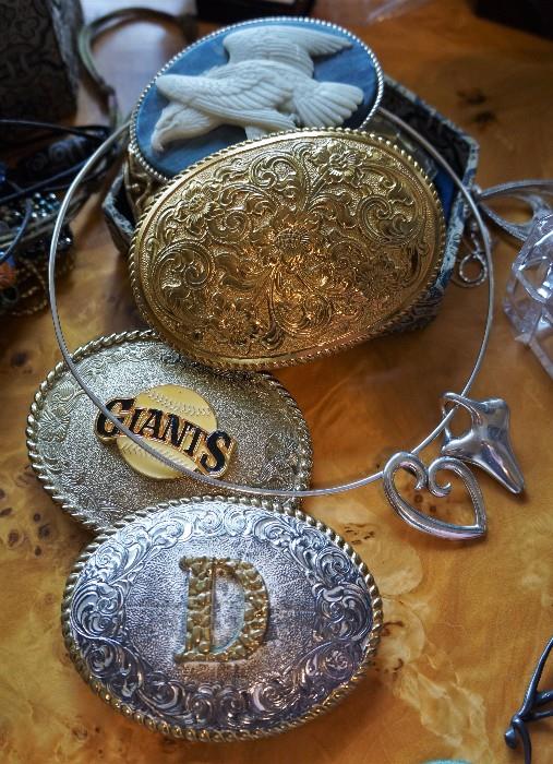 Belt buckles and some sterling jewelry. There is a James Avery and a Giani pendant on the choker