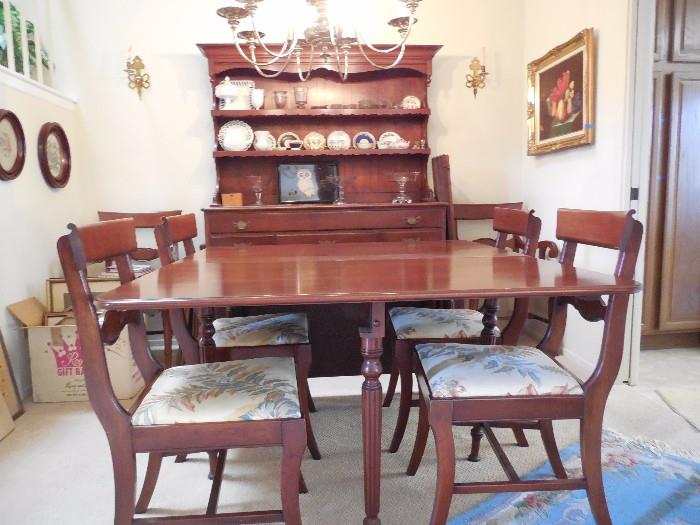 Antique hard wood dining room set with 4 armless chairs, 2 captains chairs and china hutch. Table is 46" wide. Folded down it is 28". It has 2 - 24" flip-up sides and 2 - 10.5" leaves, allowing it to expand to 97" long. Hutch is 54" wide x 72" tall. Plenty of drawer and cupboard space for linens and silverware. Table & 6 chairs $350. Hutch $200
