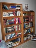 Two of three matching wood mid-century style bookcases, new and vintage books.