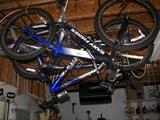 two child's bikes in work room w tools and supplies