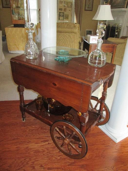 Pine rolling serving cart with crystal decanters, modern glass cake plate