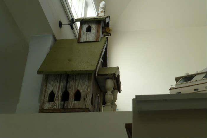 Solid wood birdhouse. displayed inside