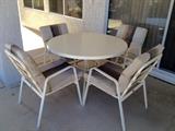 Patio table set. Cushions are white and tan.