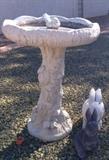 Concrete birdbath and rabbits