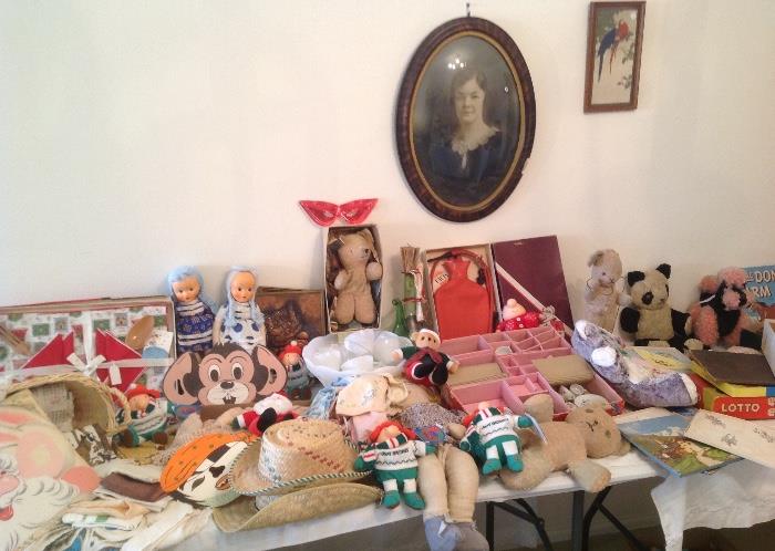 Old toys, hot water bottle, old tea set, dolls and doll clothes, old stuffed toys, vintage hankies and linens