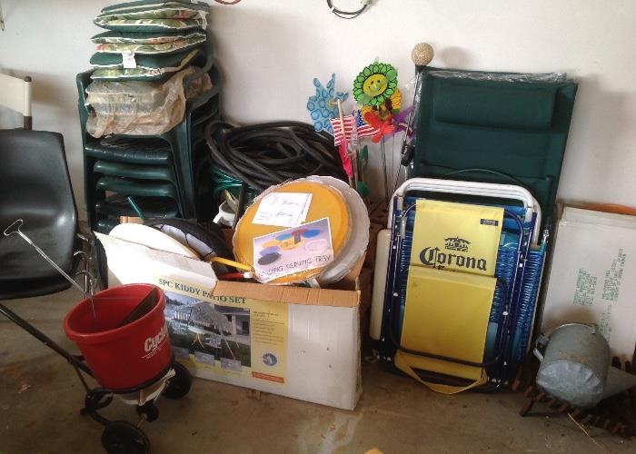 Stackable chairs, seed spreader, new in box patio tables, beach chairs, 5 pic kiddie patio set and garage items 