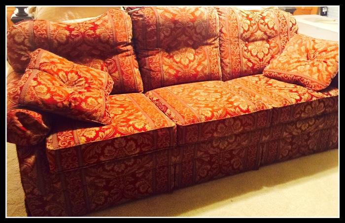 Sofa in red and gold jewel tones