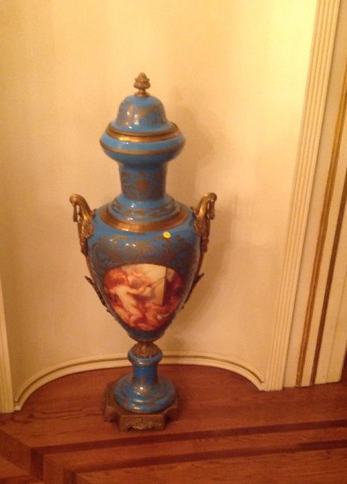 One of a pair of large 20thc Sevres style blue porcelain urns painted with cherubs