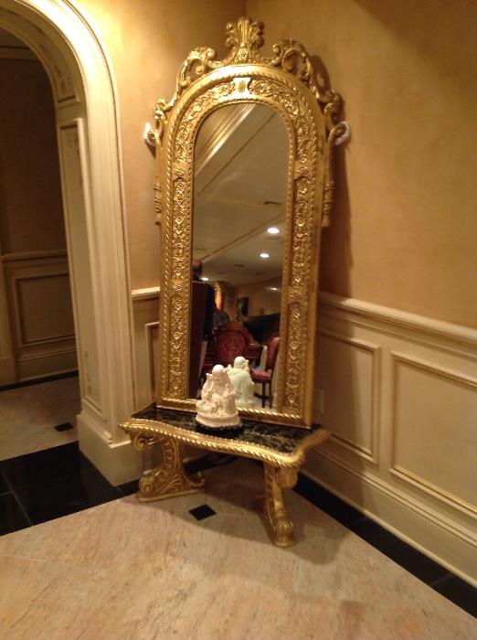 Carved giltwood arch top mirror and marble top console