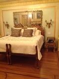 Pair of French style twin beds used as a kingsize bed, pair of bronze sconces