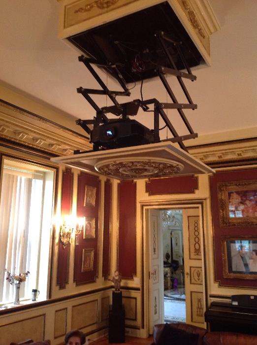 Projection tv system with huge screen that recesses into ceiling