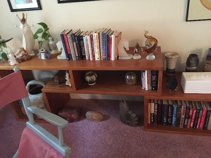 Contemporary shelving unit and various pottery and collectibles.