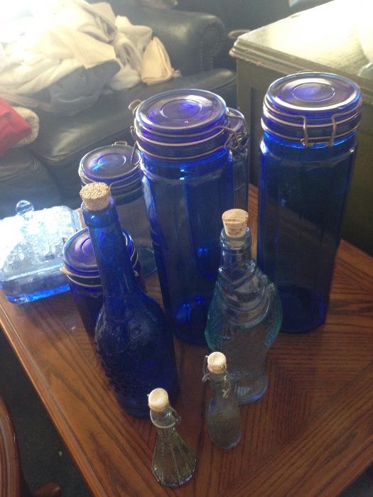 large collection of blue glass items, jars, containers, glasses