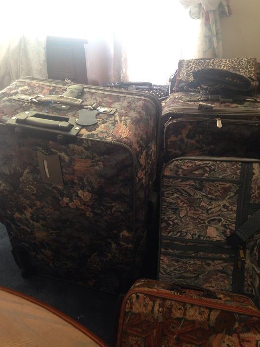 large collection of suit cases, tapestry and others, some never used
