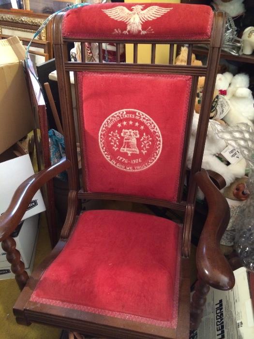 Antique-style rocking chair with embroidered red upholstery commemorating the US Bicentennial (1776-1976).