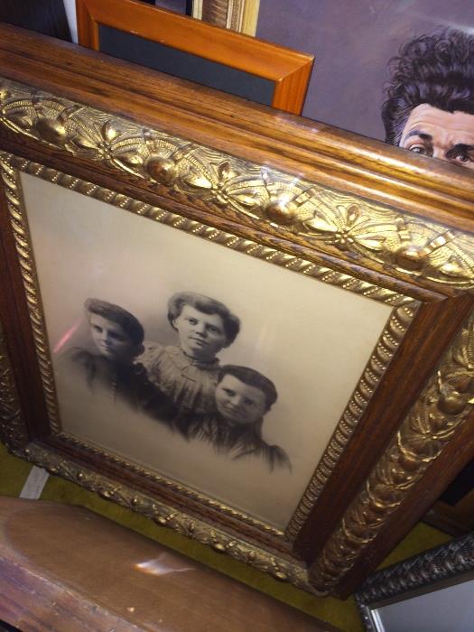 Beautiful antique frame with period photo, many other pictures, paintings and wall décor. Is that Kramer I see peeking through?