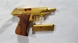 Walther Manurhin PP Mark II .380 Automatic Pistol - Reported by seller to be gold plated, this French made Walther Manurhin PP comes with two "gold" magazines, felt lined display case, manual and cleaning rod. Ornately engraved 9mm short .380 Caliber