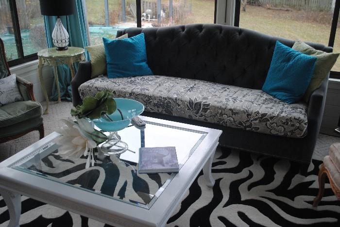 Velveteen couch, accent pillows, glass top coffee table