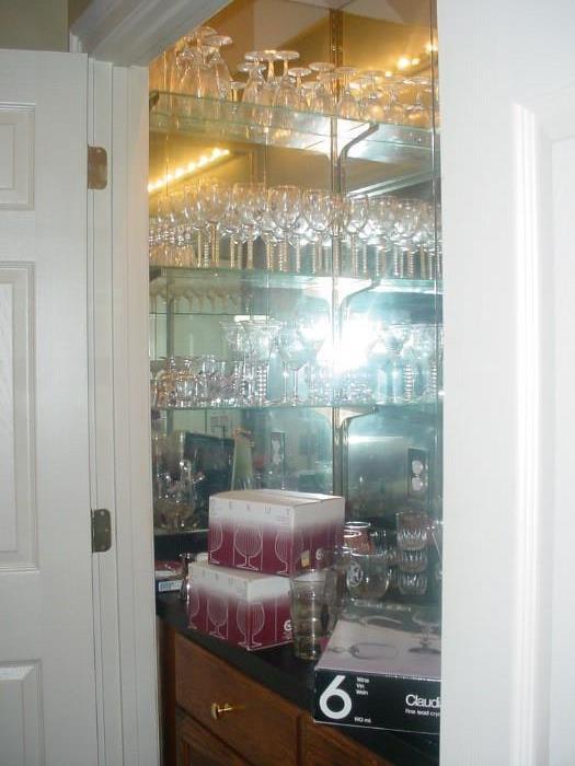 Bar area filled with variety of glassware and bar equipment and supplies