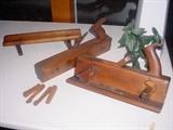 Several vintage wood planes and other tools