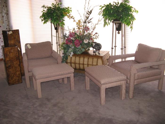 Accent Chairs with ottomans, tall plant stands and a pair of burl wood display pedestals.