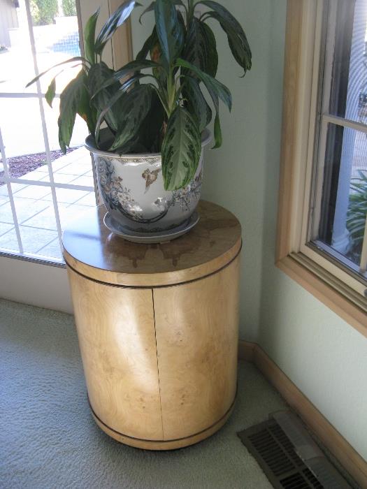 One of a pair of burl wood accent tables.