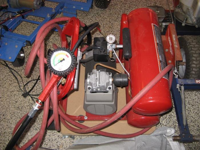 Compressor with air hoses and accessories.