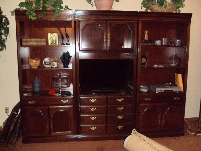 ENTERTAINMENT CENTER, DOORS ARE NEXT TO IT THAT CAN BE PUT ON IF YOU DO NOT WANT TO USE THE SHELVES FOR DISPLAY. THREE PIECES SO IT COULD BE PUT IN DIFFERENT AREAS OF YOUR HOME. FLAT SCREEN TELEVISION