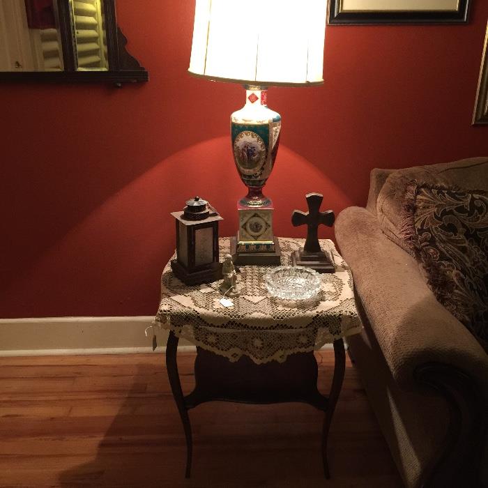 end table with vintage lamp, doillie, cross, clock 