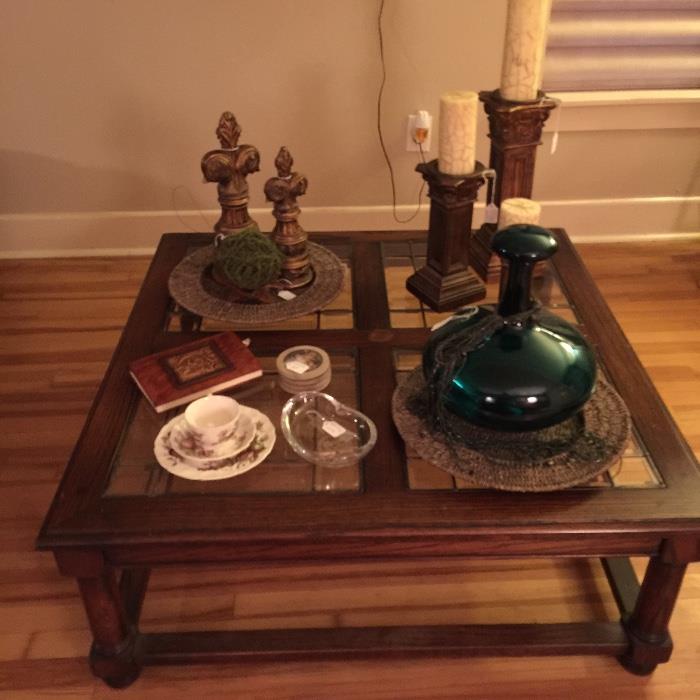 coffee table with large green Murano glass bottle, three candle holers, two decorative finials, deco ball, misc.