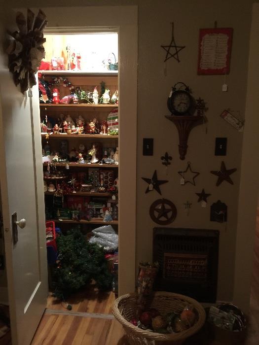 closet full of Christmas items, Christmas items scattered around house also, cast iron wall art