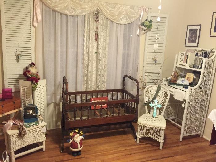 antique cradle from first elected judge in Tyler, wicker chair, corner cabinet, foot stool, shelf /desk, misc small items, lace curtains