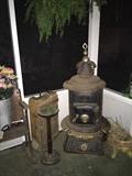 antique wood burning stove, floor ashtray, ammo box, turtle planter