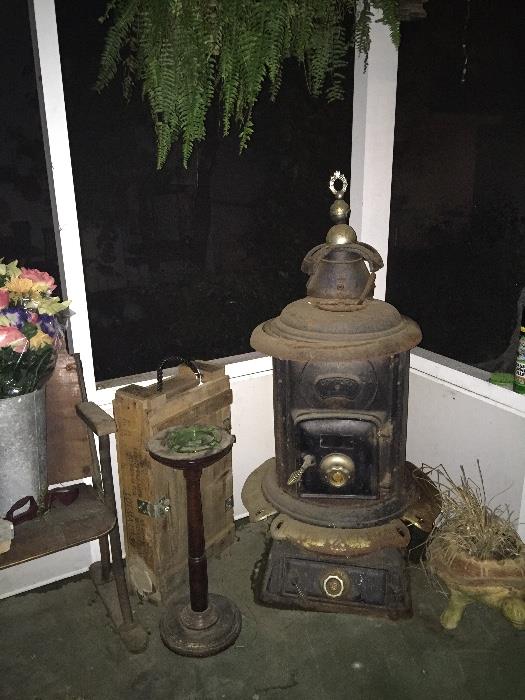 antique wood burning stove, floor ashtray, ammo box, turtle planter