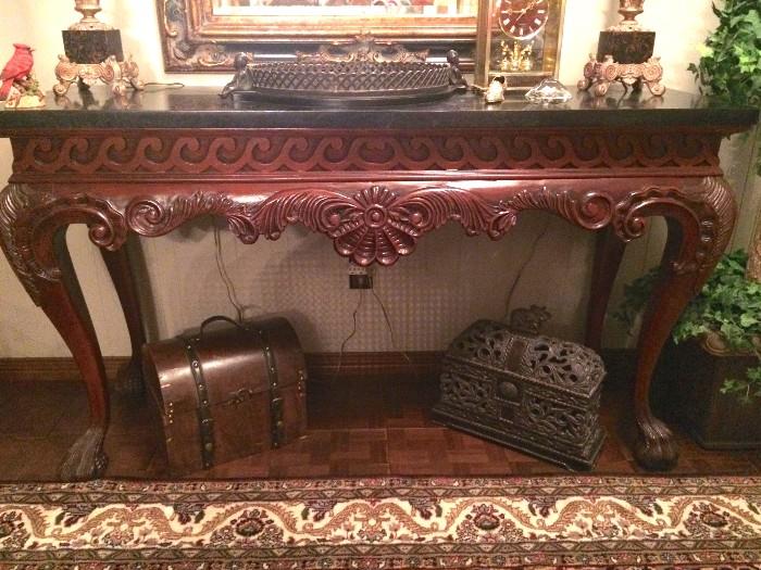 Impressive console table with carved clawfoot legs and black marble top