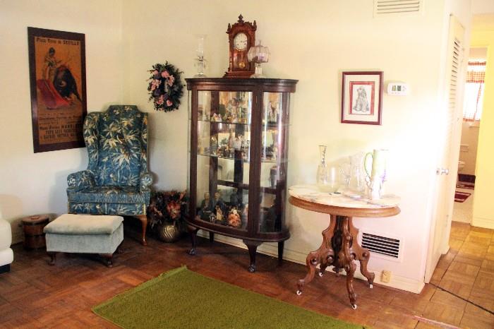 Nice curio cabinet and little marble top table.  One of many clocks.