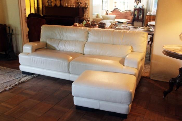 Modern white leather sofa and ottoman.