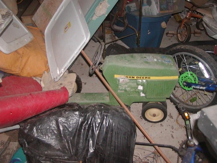 bought in 1976 at feed store in Ellington, Fla. John Deere Peddle Tractor (narrow wheels on front) metal seat, (trailer may still be in there too.)