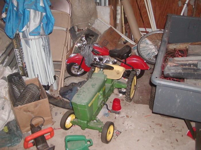 wide wheel base john deere peddle tractor, bought in antique store in the Eufaula, Ok area. cast iron but plastic seat. battery operated motor cycle.  there is also a red peddle car and several bicycles.  in picture is also one of the pop up canopies