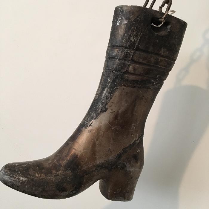 This is a metal mold of a boot was used outside an old boot or shoemakers' shop
