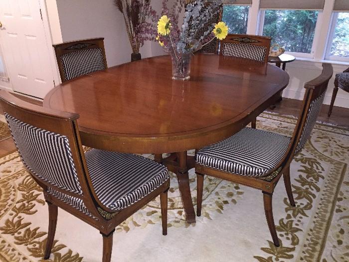 formal dining room table with 4 chairs. wool rug