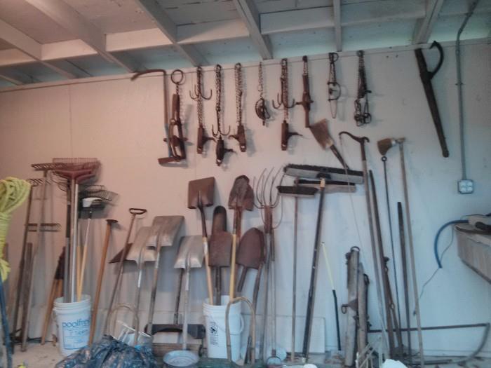 Vintage traps, saws, tools, burlap sacks, cow bells,  scythes, and many more farm & yard items