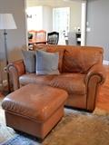 Leather loveseat with nailhead trim and matching ottoman